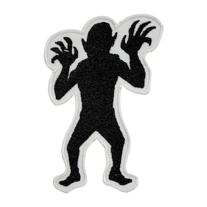 May include: Black embroidered patch of a monster silhouette with clawed hands raised in the air.