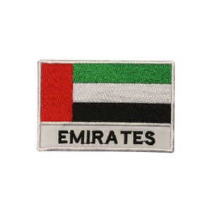 May include: Embroidered patch featuring the United Arab Emirates flag. The flag design includes a vertical red stripe on the left, with horizontal stripes of green, white, and black. The word "EMIRATES" is embroidered below the flag.