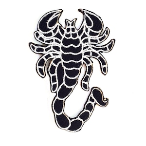 May include: Black and white embroidered scorpion patch. The scorpion is outlined in white and has a detailed design.
