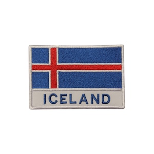 May include: An embroidered patch featuring the flag of Iceland. The patch is blue, red, and white with the text "ICELAND" below the flag.