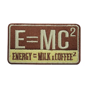 May include: A brown and yellow embroidered patch with the text "E=MC²" and the text "ENERGY = MILK x COFFEE²" below it.