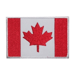 May include: A red and white embroidered Canadian flag patch. The flag features a red maple leaf on a white background with red stripes on either side.