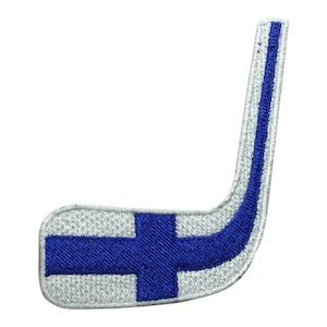 May include: A white hockey stick with a blue Finnish flag design. The flag has a white cross on a blue background.