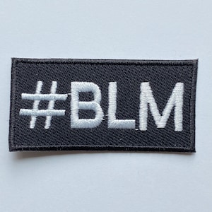May include: Black fabric patch with white embroidered text that reads "#BLM".