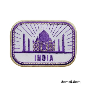 May include: Purple embroidered patch with a white background featuring an outline of the Taj Mahal and the word "INDIA" in gold lettering. The patch is 8 cm by 5.5 cm.