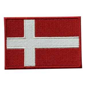 May include: A red and white embroidered patch featuring the flag of Denmark. The white cross is centered on a red background.