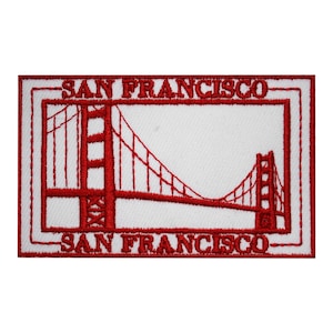 Peut inclure: Patch brodé rouge sur fond blanc représentant un contour du Golden Gate Bridge et le texte "SAN FRANCISCO" au-dessus et en dessous du pont.