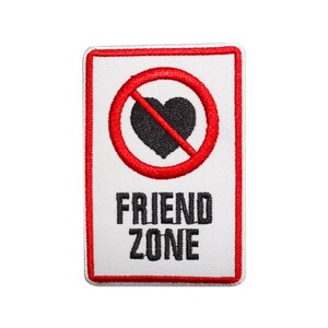 May include: A white patch with a red border. A red circle with a diagonal line through it contains a black heart. The text "FRIEND ZONE" is below the circle.