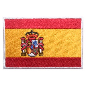 May include: Embroidered patch of the Spanish flag. The flag is red, yellow, and red with the Spanish coat of arms in the center.