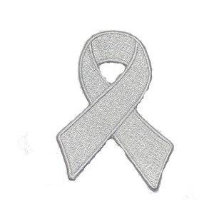 May include: A silver awareness ribbon patch with a textured appearance. The ribbon is embroidered with a satin stitch and has a defined border. The patch is designed to be ironed or sewn onto fabric.