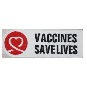 May include: White rectangular patch with the text "Vaccines Save Lives" in black lettering. A red heart with a white outline is on the left side of the patch.