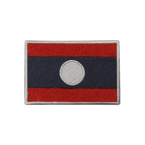 May include: An embroidered patch of the Laotian flag. The flag is red, blue, and white with a white circle in the center.