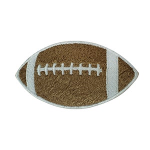May include: An embroidered patch shaped like a rugby ball, with brown and white stitching.