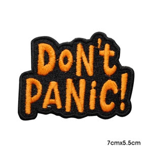 May include: Orange embroidered patch with the text "Don't Panic!" on a black background. The patch is approximately 7 inches by 5.5 inches.