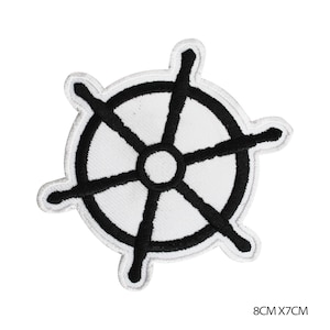 May include: Black and white embroidered iron-on patch of a ship's wheel. The patch is 8 inches by 7 inches.