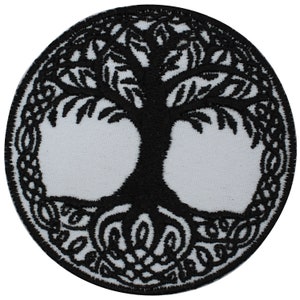 May include: Black embroidered iron-on patch featuring a tree of life design. The tree is encircled by a circular pattern of leaves and vines.