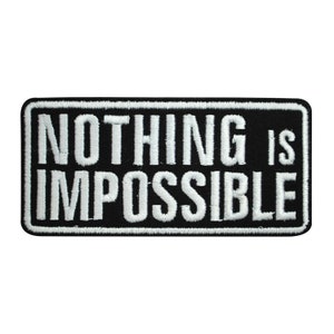 May include: Black embroidered patch with white text that reads "NOTHING IS IMPOSSIBLE".