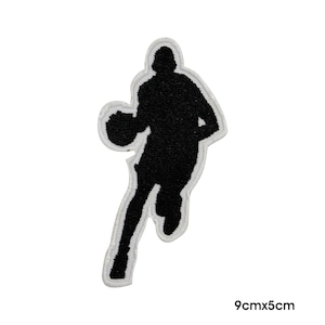 May include: Black embroidered iron-on patch of a basketball player silhouette dribbling a ball. The patch measures 9cm by 5cm.