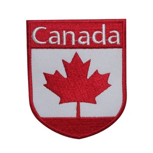 May include: Red and white embroidered patch with a maple leaf and the word "Canada" in white lettering.