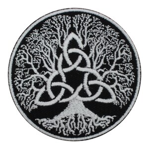 May include: White embroidered Celtic tree of life patch on a black background. The tree is surrounded by a triple knot.