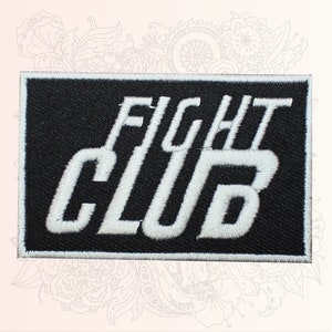 May include: Black and white embroidered patch with the text "FIGHT CLUB" in white lettering.
