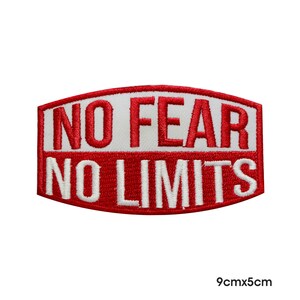 May include: Red and white embroidered patch with the text "NO FEAR NO LIMITS" in a curved shape. The patch measures 9cm by 5cm.