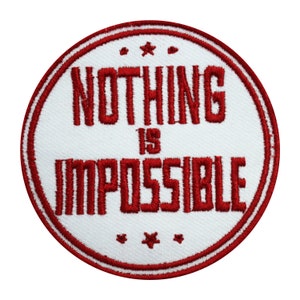 May include: Red embroidered patch with white background. The patch is round and has a red border. The text on the patch reads "Nothing is Impossible".