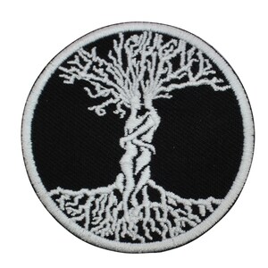 May include: White embroidered tree of life patch on a black background. The tree is stylised with a human figure intertwined with the trunk and roots.