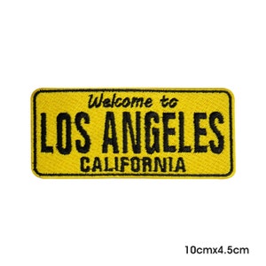 Peut inclure: Écusson brodé jaune avec du texte noir qui dit "Welcome to Los Angeles California". L'écusson mesure 10 cm x 4,5 cm.