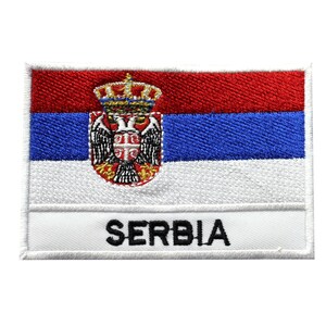 May include: Embroidered patch with the Serbian flag and the word "SERBIA" in black lettering. The flag features a red, blue, and white color scheme with the coat of arms of Serbia in the center.