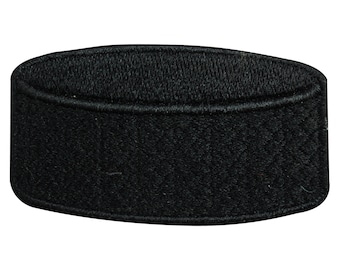 May include: Black embroidered hockey puck patch. The patch is a flat, circular shape with a raised edge.