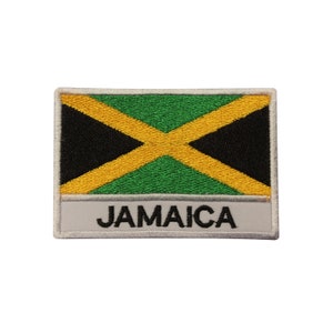 May include: A white embroidered patch with the Jamaican flag and the word "JAMAICA" in black lettering.