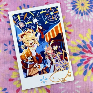 May include: A colorful illustration of three anime characters standing in front of a fireworks display. The characters are wearing colorful outfits and are smiling. The background is a dark blue sky with fireworks exploding in the air. The image is framed with a white border and a white fish with orange fins.