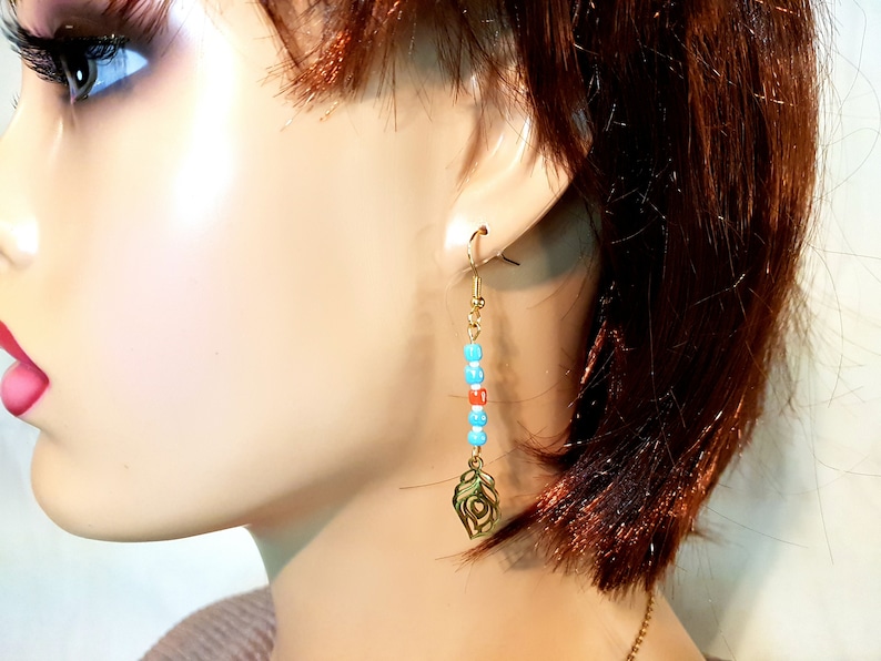 Long feather gold pendant earrings with blue and red glass beads