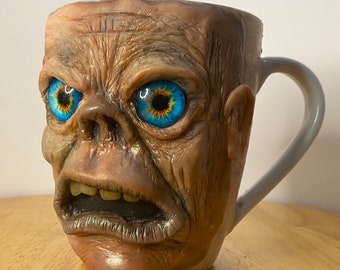 Uglymug - each sculpture is a hand made one of a kind coffee Mug. His name is “Rob”