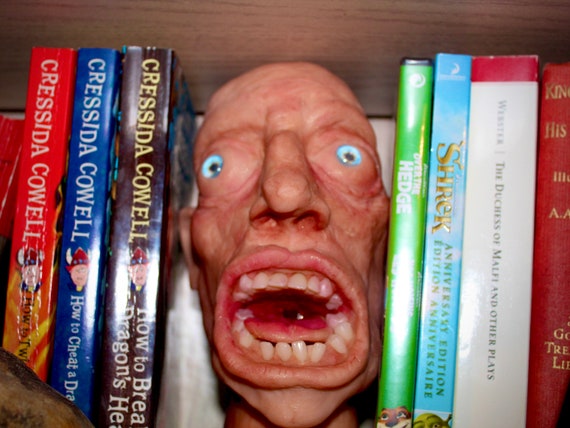 Scary face, book-between book shelf accessory
