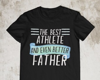 May include: Black t-shirt with white text that reads "The Best Athlete And Even Better Father" on a blue ribbon.