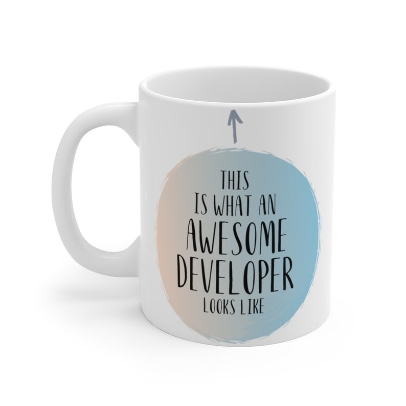 Pode incluir: Caneca de cer&acirc;mica branca com um gr&aacute;fico circular azul e laranja que diz "&Eacute; assim que um desenvolvedor incr&iacute;vel parece". Uma seta aponta para cima acima do c&iacute;rculo.