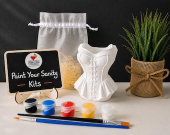 May include: A white ceramic corset-shaped planter, a small chalkboard sign with the text Paint Your Sanity Kits, a translucent drawstring bag, five small paint pots in black, blue, red, yellow, and white, and two paintbrushes.