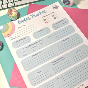 May include: A printable order tracker form with a light blue background and pink, yellow, and green accents. The form includes sections for client info, event theme, due date, payment method, product type, custom details, and to do.