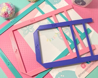 May include: Four plastic frames in different sizes, 3x3, 4x4, 5x5, and 7x7 inches, for creating pom poms. The frames are in pink, blue, and turquoise colors. The frames are on a pink and white polka dot background.