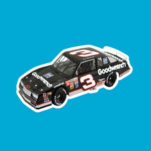 May include: A black toy car with the number 3 on the side and the words "Goodwrench" on the side. The car is a 1980s era Chevrolet Monte Carlo.