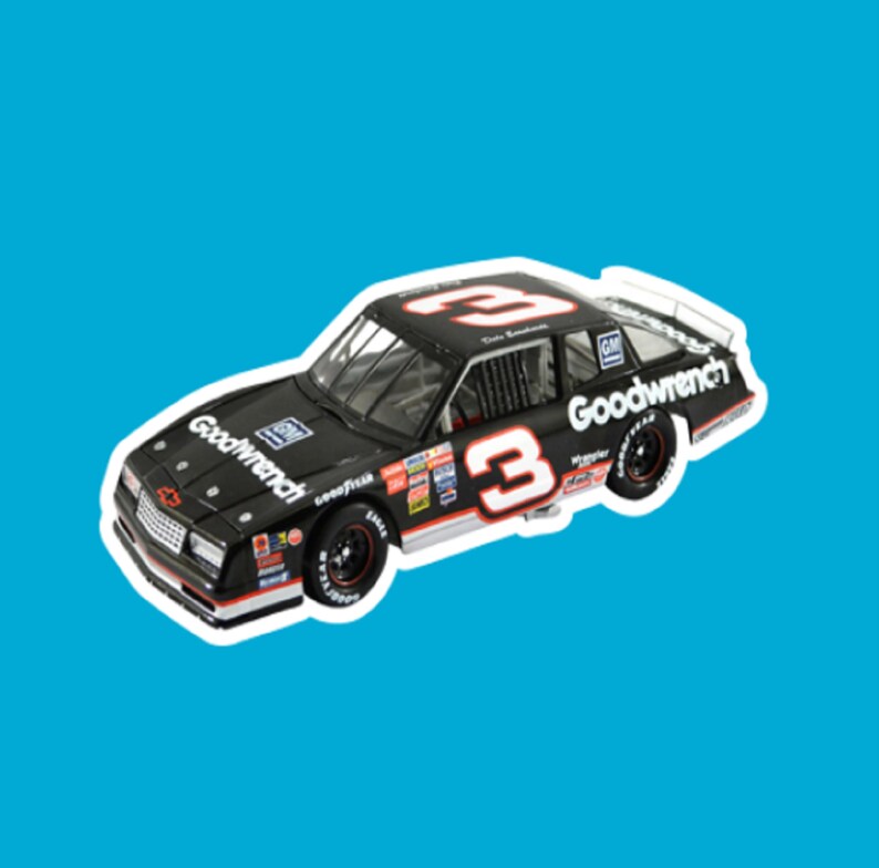 May include: A black toy car with the number 3 on the side and the words "Goodwrench" on the side. The car is a 1980s era Chevrolet Monte Carlo.