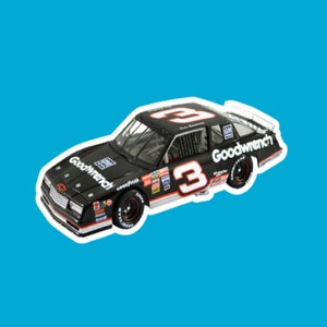 May include: A black toy car with the number 3 on the side and the words "Goodwrench" on the side. The car is a 1980s era Chevrolet Monte Carlo.