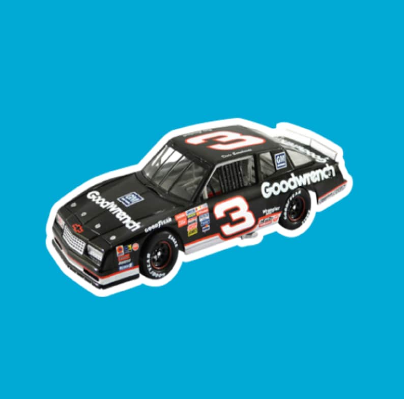 May include: A black toy car with the number 3 on the side and the words "Goodwrench" on the side. The car is a 1980s era Chevrolet Monte Carlo.