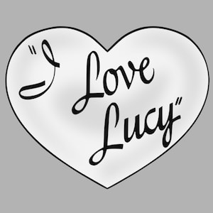 May include: A white heart with black cursive writing that says "I Love Lucy"