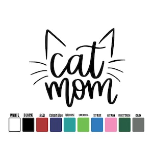 May include: A white background with the words "cat mom" in a black, cursive font, with cat ears and whiskers above the text. Below the text are color swatches labeled with various colors, including white, black, red, and gray.