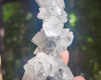 Doubly terminated apophyllite crystals on black chalcedony stalactite