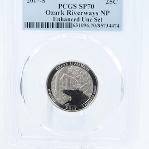 May include: A 2017-S Ozark Riverways NP 25-cent coin, graded PCGS SP70, encased in a protective holder. The coin features a detailed design of a river scene and the text "Ozark Riverways" and "Missouri".