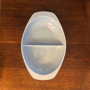 May include: A light blue oval-shaped divided serving dish with a smooth, glossy finish.